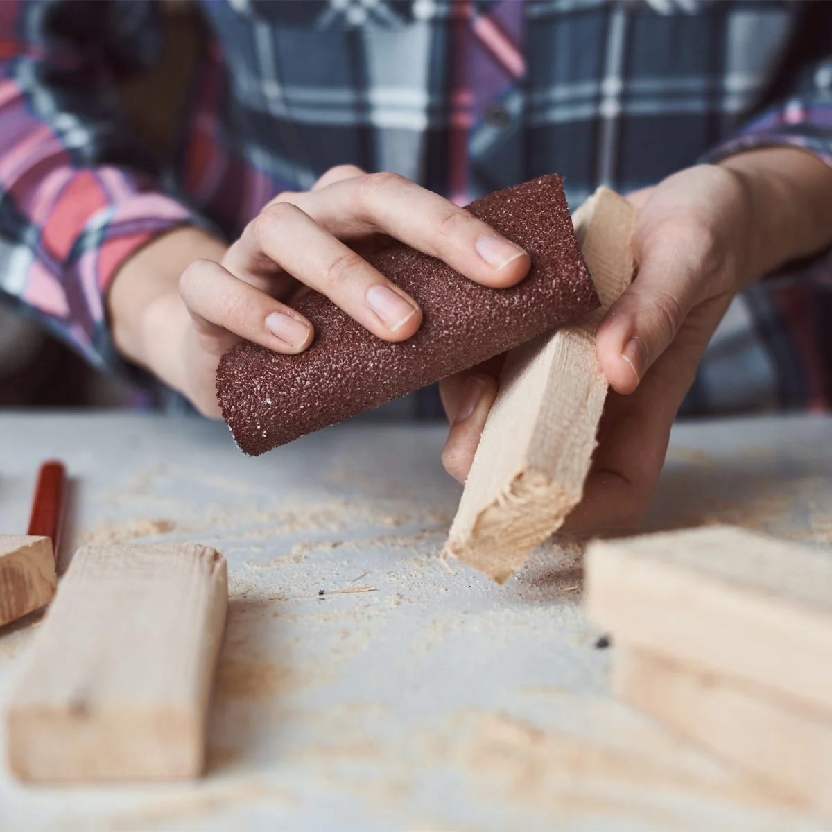 woman-using-sandpaper-Aliaksandr-Barysenka-GettyImages-12843573082.webp